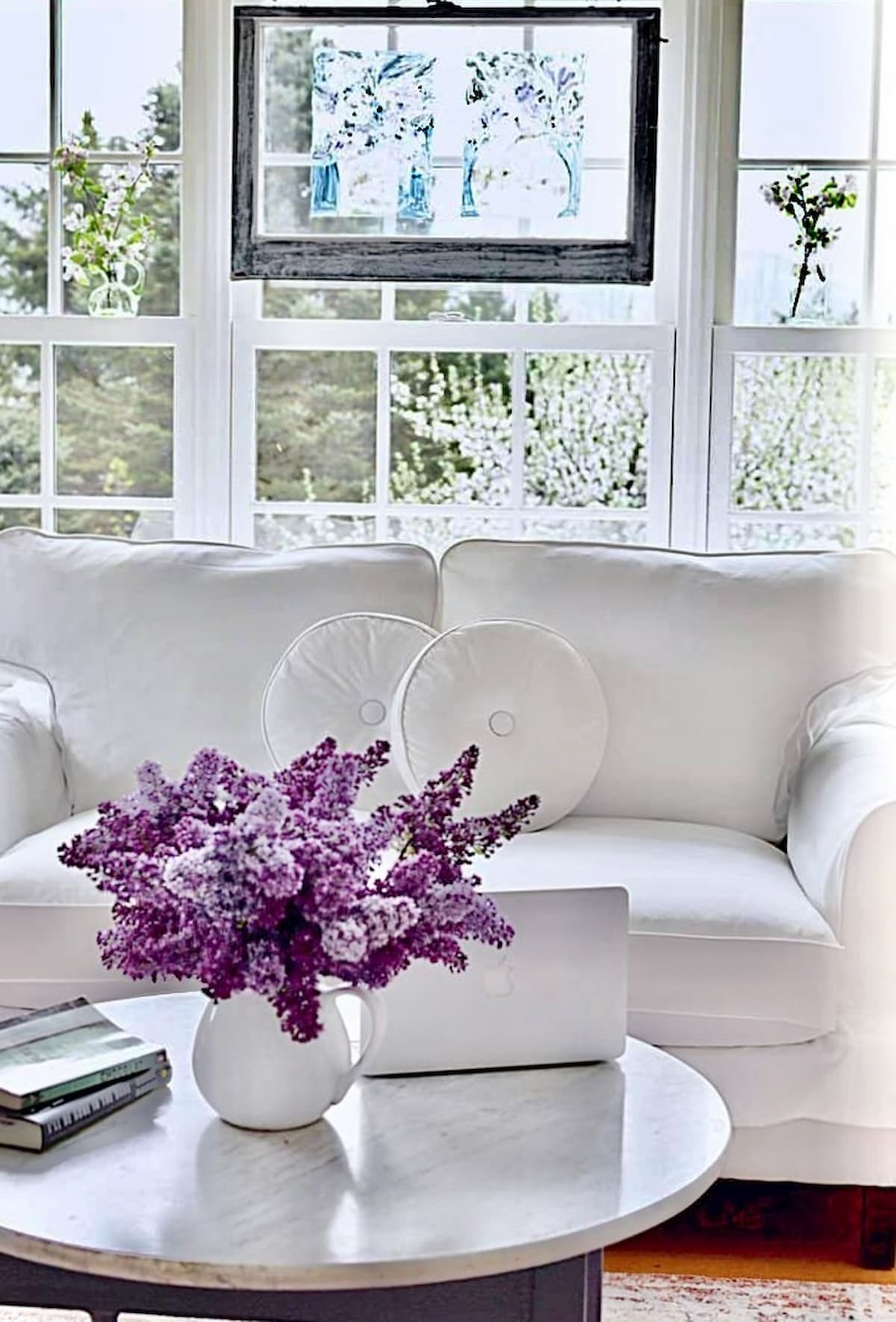 Vintage Room sunroom with lilacs and white furnishings